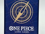 a close up of a one piece card game on a stand