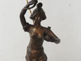 an image of a bronze statue of a woman holding a lamp