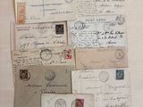 many old letters and envelopes laid out on a table