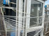 a large stack of windows sitting on a pallet in a warehouse