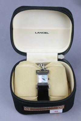 an image of a watch in a case on a table