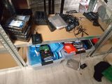 a shelf with many electronics on it in a room