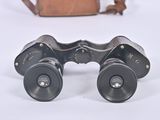 a pair of binoculars sitting on a white surface
