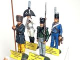 five figurines of soldiers on display in a display case