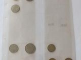 a lot of coins in a plastic bag on a table