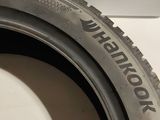 a close up of a tire on a white surface