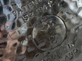a close up of a silver vase with a picture on it