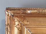 a picture of a picture of a gold frame on the wall