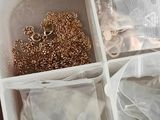 a white container filled with jewelry and a pair of scissors