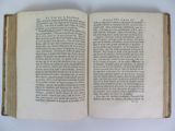 an open book on a table with a white background