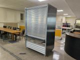 a room with a table, chairs, and a refrigerator in it