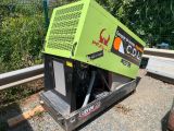 a green machine that is sitting on the side of the road