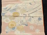a piece of cloth with a picture of a bird and flowers on it