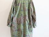 an image of a woman ' s coat on a mannequin mannequin stand