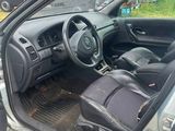 the interior of a car with the door open and the driver ' s seat down