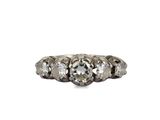 a close up of a three stone ring on a white background