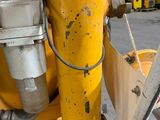 a close up view of a yellow machine in a warehouse