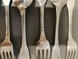 four forks that are sitting next to each other