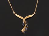 a gold necklace with a blue sapphire stone and a gold chain