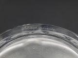 underside view of a clear glass bowl with a black background