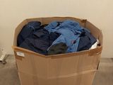 a cardboard box with clothes in it sitting on the floor