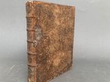 an old book sitting on top of a table next to a gray background