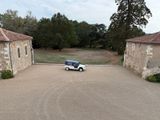a small car parked in the driveway of a house