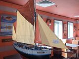 a model of a sailboat on display in a room