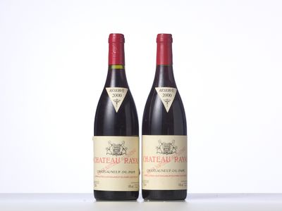 two bottles of red wine sitting next to each other on a table