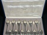 six forks in a blue case with silverware in it