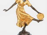 bronze statue of a woman holding a fan on a black base