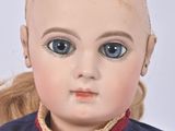 a close up of a doll with a messy hair