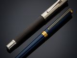 a pen and a ballpoint pen on a black background