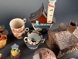 many different types of pottery sitting on a table