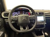 the interior of a car with a steering wheel and dashboard controls