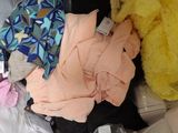 a bag of clothes and a teddy bear inside of it