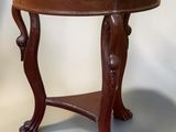 a small table with a marble top on a white background