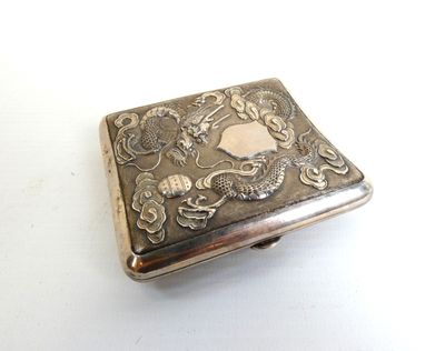 a silver box with a picture on it on a white surface