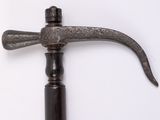 an old hammer that is sitting on a white surface