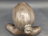 a sculpture of an onion on a wooden stand