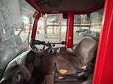 a red truck with a seat and a steering wheel