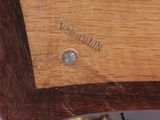 a close up of a wooden table with a clock on it