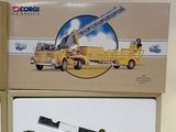 two boxes that have a yellow truck and a crane on them