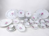 many different types of plates and bowls on the table
