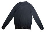 a close up of a black sweater with sequins on it
