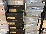 several stacks of boxes stacked on top of each other in a room