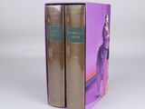 two books in a purple box on a white surface