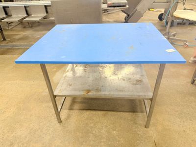 a blue table that is sitting in the middle of a room