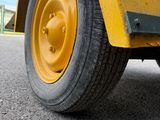 a yellow truck that is parked on the side of the road