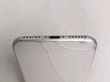 an iphone with a broken screen sitting on top of a table